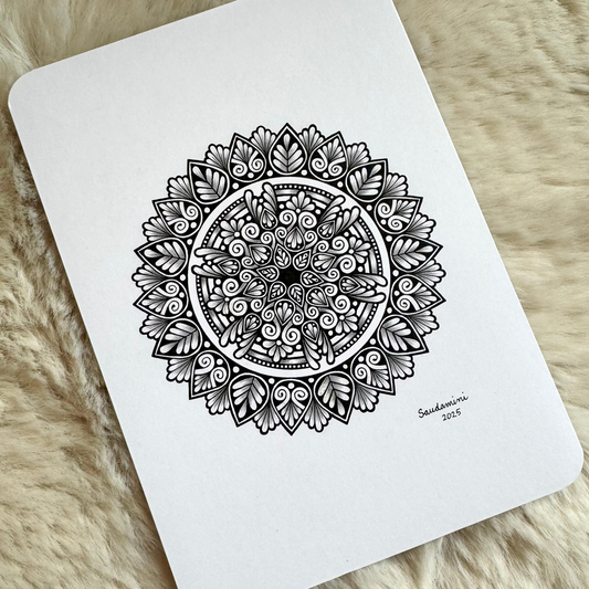 Black mandala artwork on a textured surface