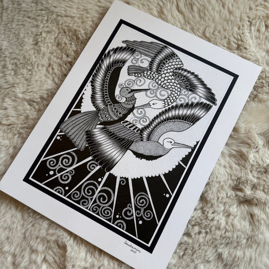 Hand-drawn zentangle by Saudamini Madra showing two birds in flight in black ink on Bristol paper, photographed on textured surface