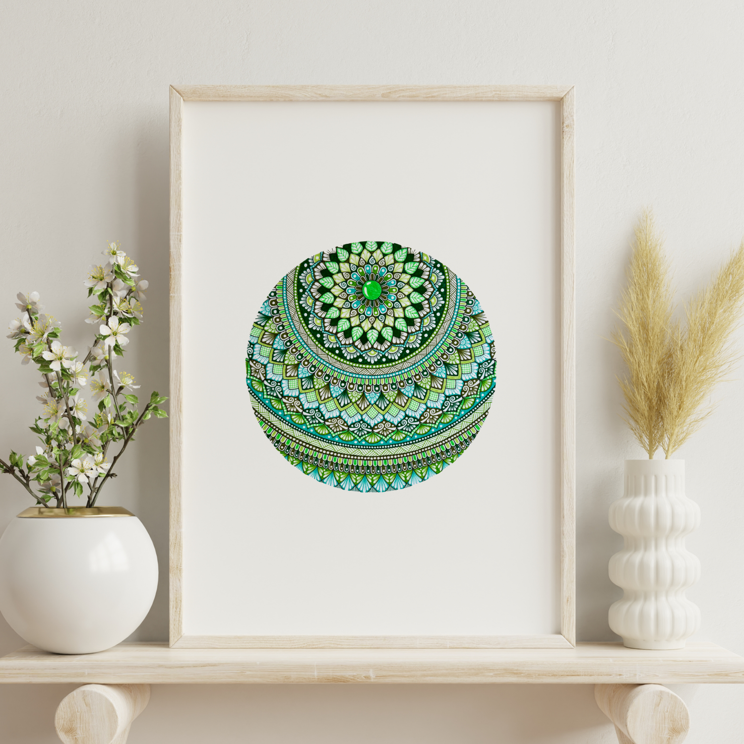 Green mandala artwork hanging on a wall near decorative plants
