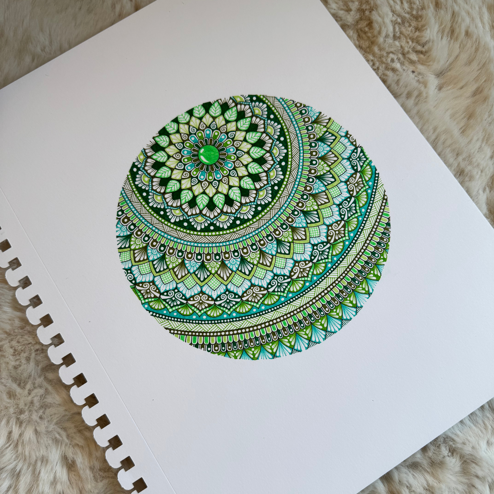 Colorful mandala design, resting on a textured surface