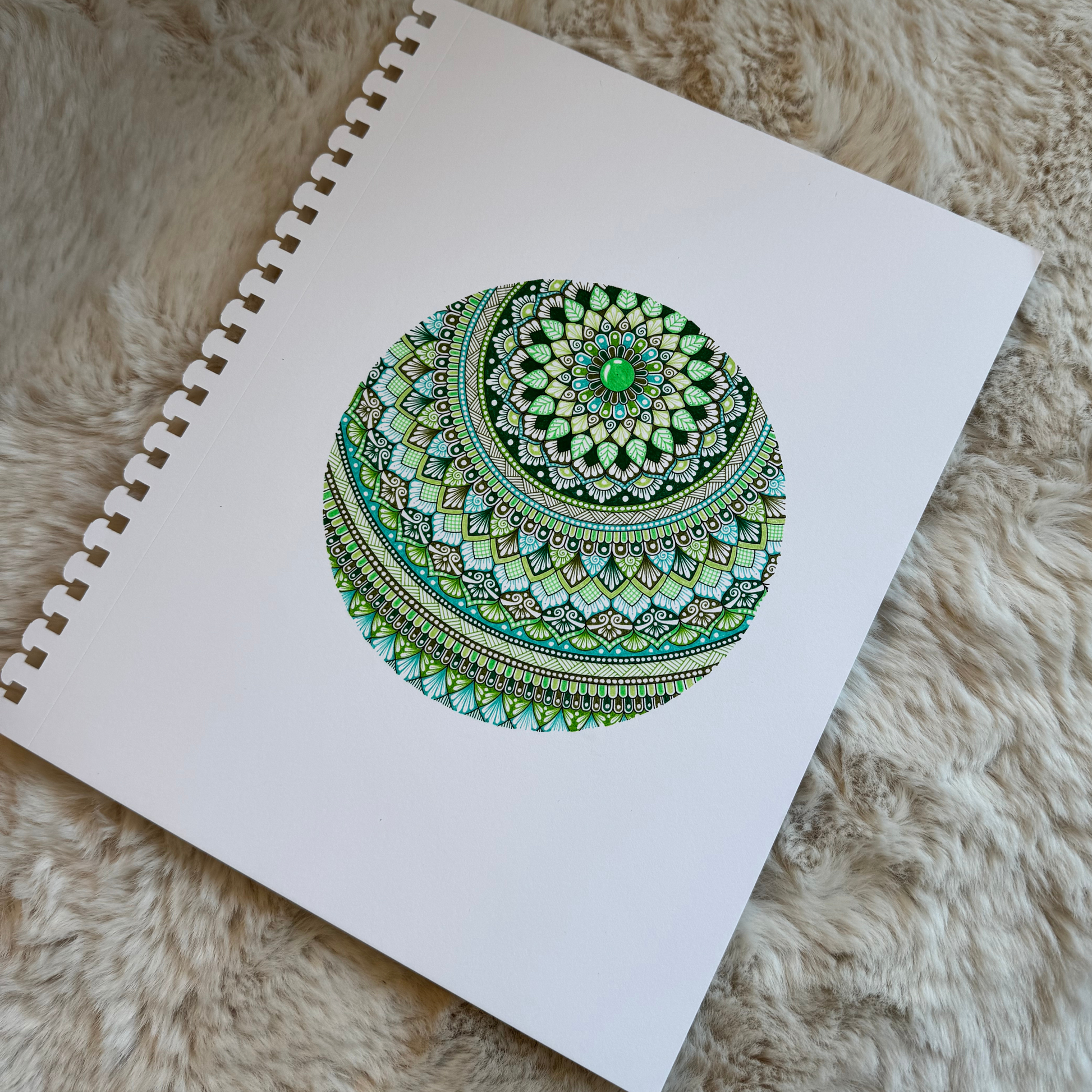 Colorful mandala design, resting on a textured surface