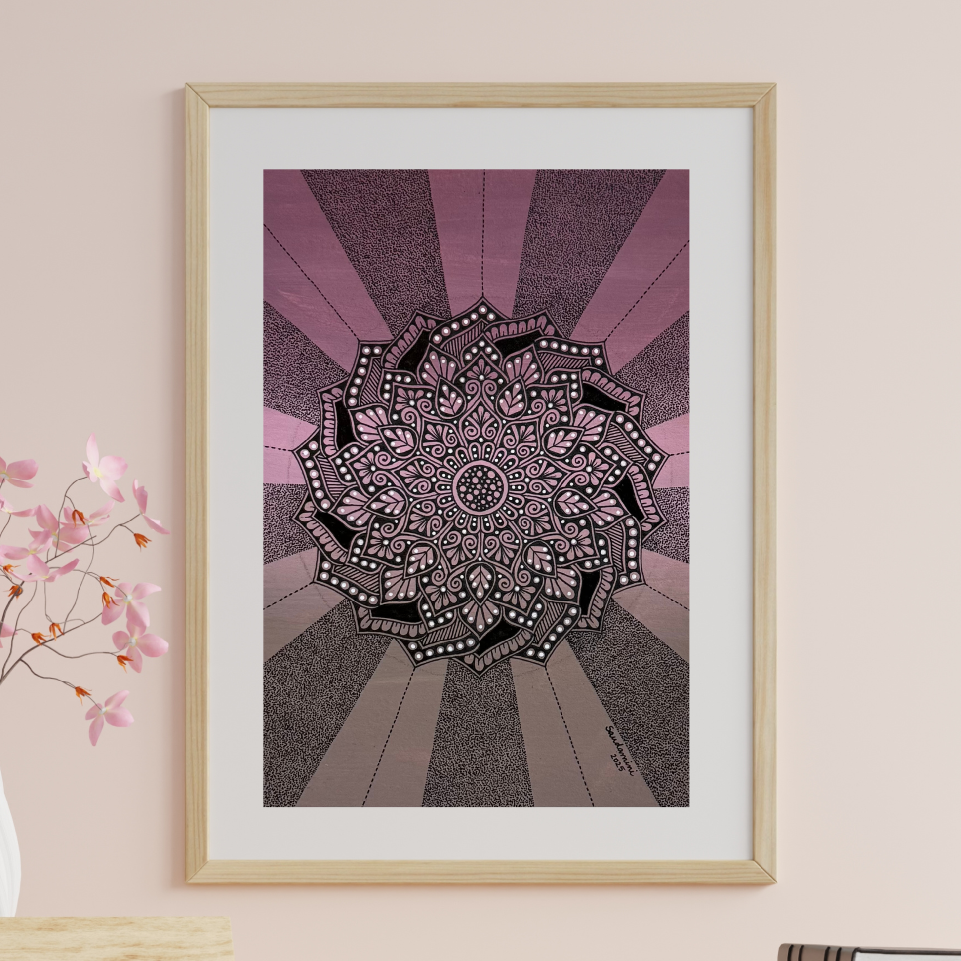 Mandala art on a wall with a light pink background