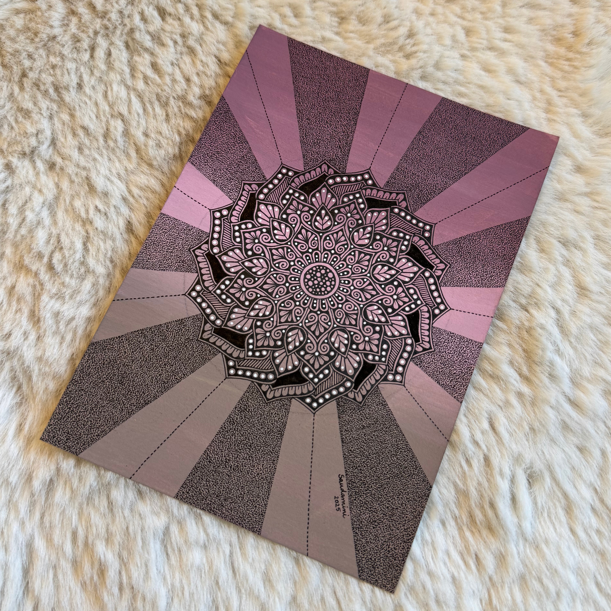 Decorative mandala design on a fluffy white surface