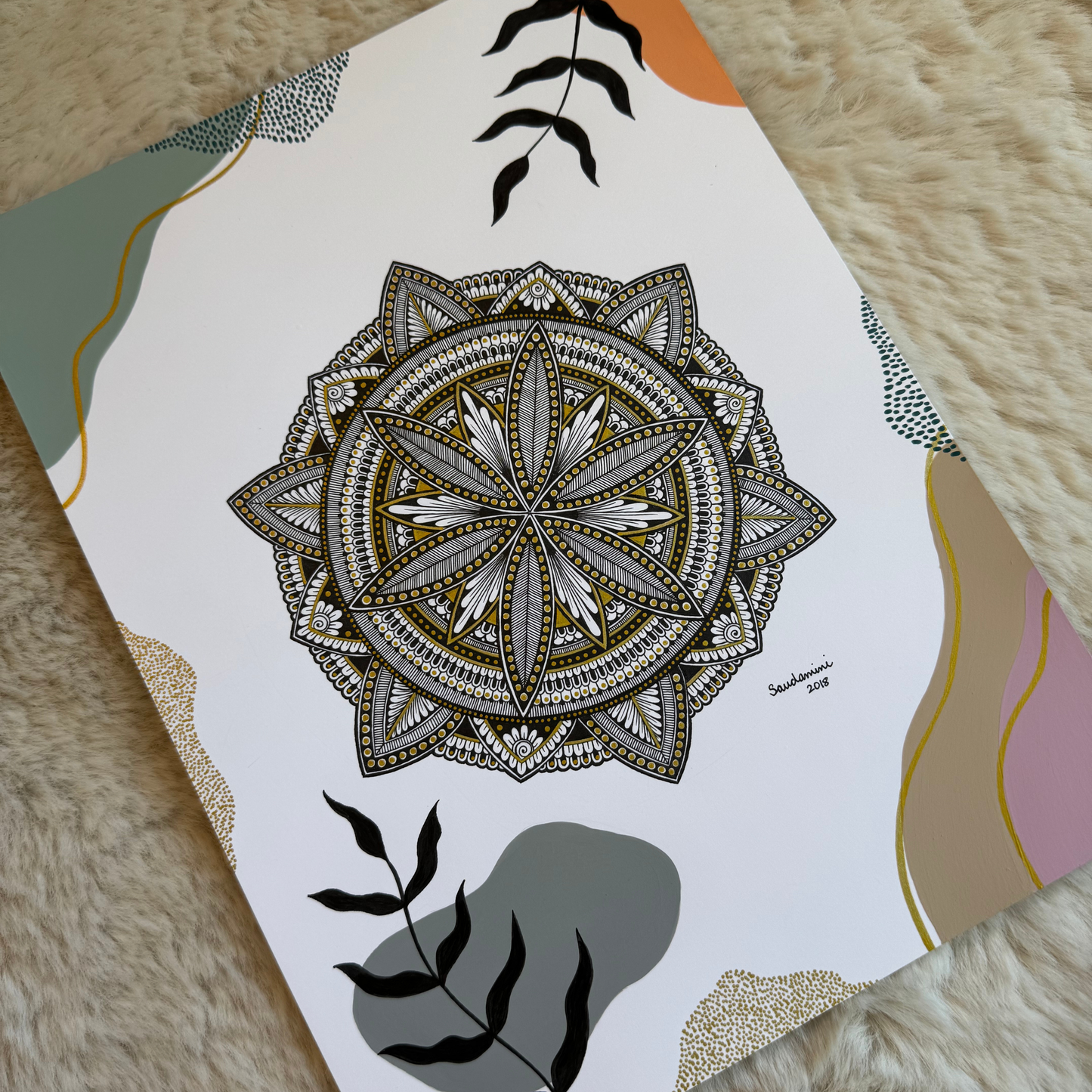 Mandala design on a piece of paper with decorative elements on a textured surface
