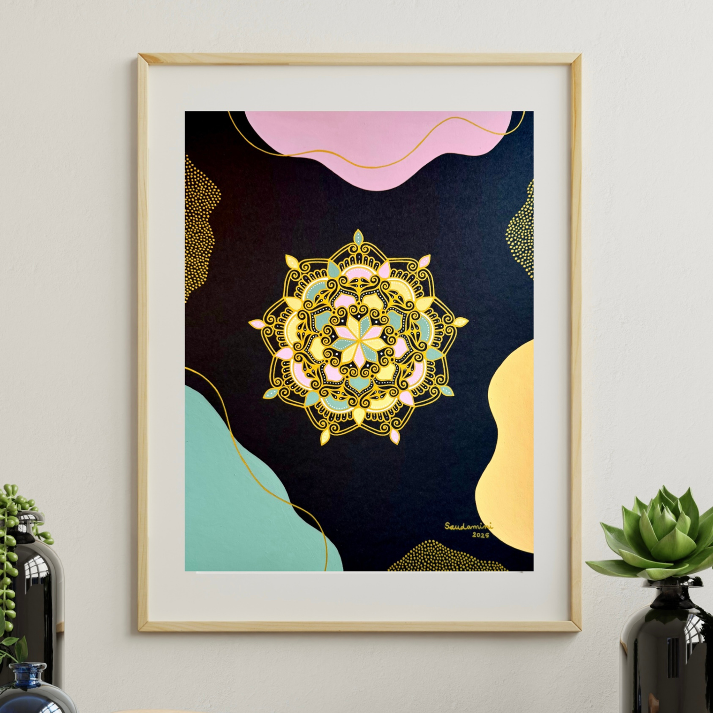 gilded blossom of night mandala hanging on a wall with decorative plants nearby
