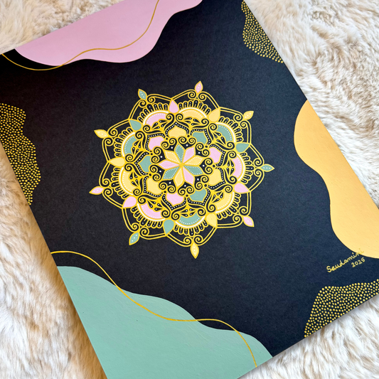gilded blossom of night mandala resting on a textured surface