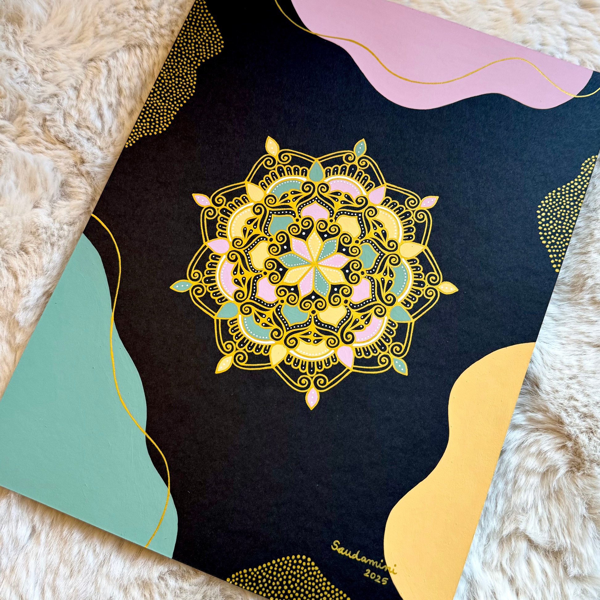 gilded blossom of night mandala resting on a textured surface