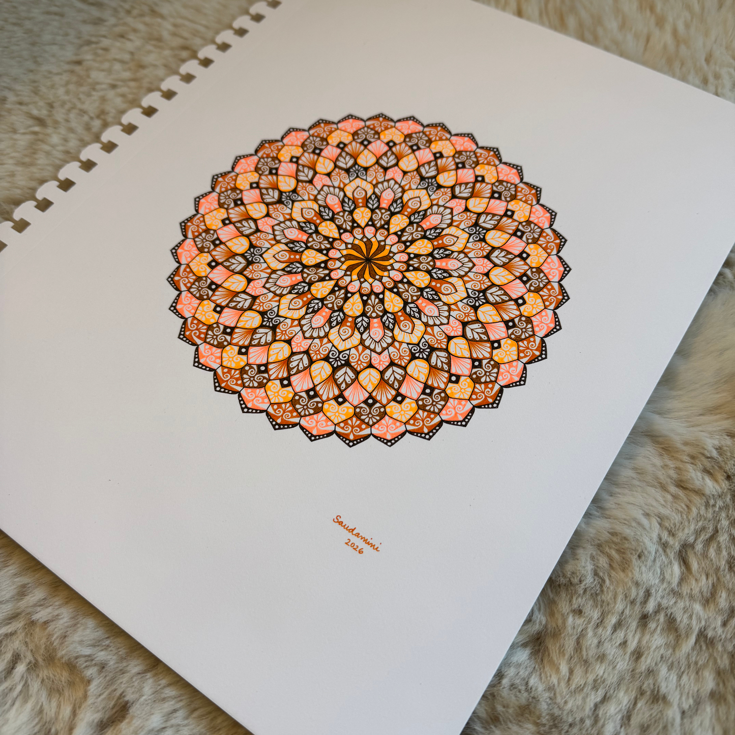 Colorful mandala drawing resting on a textured surface