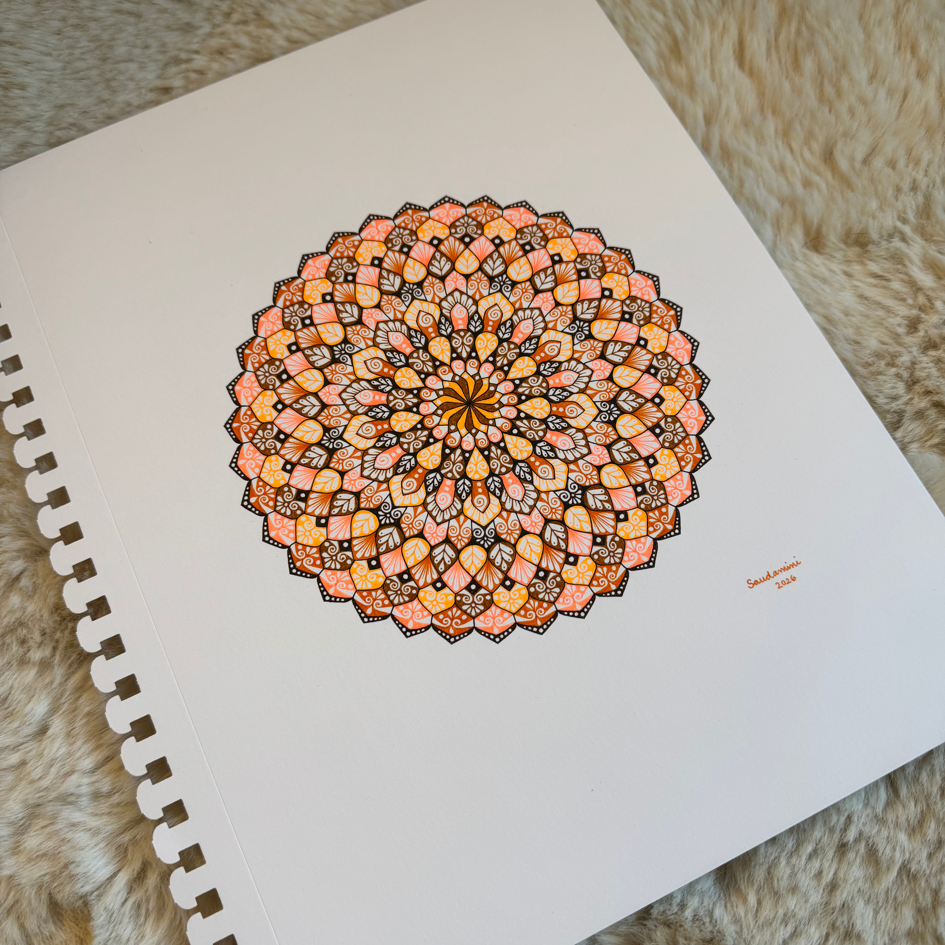 Colorful mandala drawing resting on a textured surface