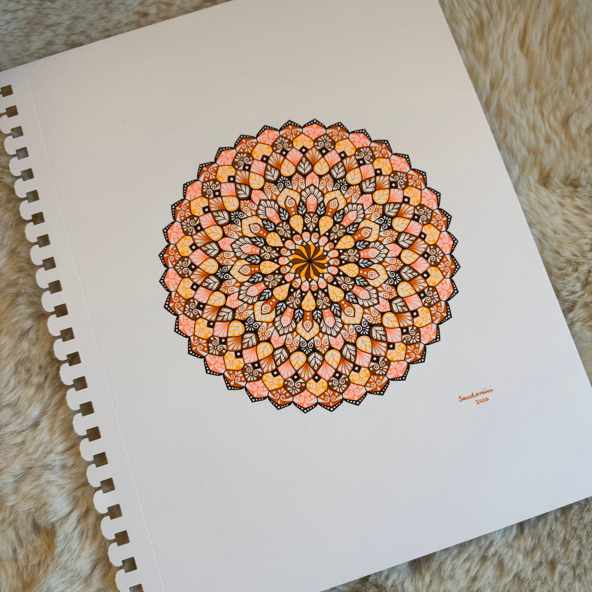 Colorful mandala drawing resting on a textured surface