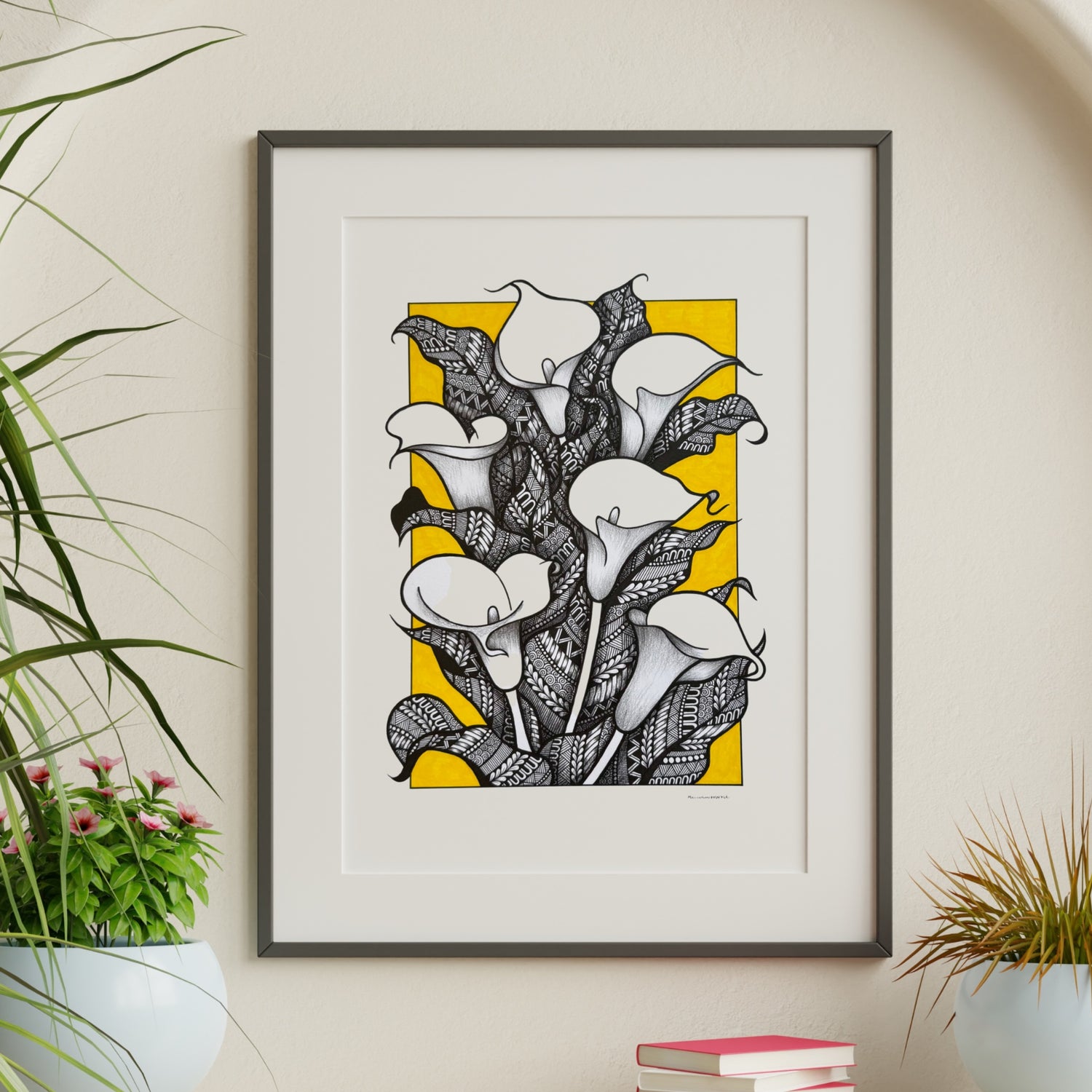 Composite mockup of Lilies That Kept Vigil Zentangle by Saudamini Madra, calla lilies in black ink with yellow ground on Bristol paper, shown framed in a styled room