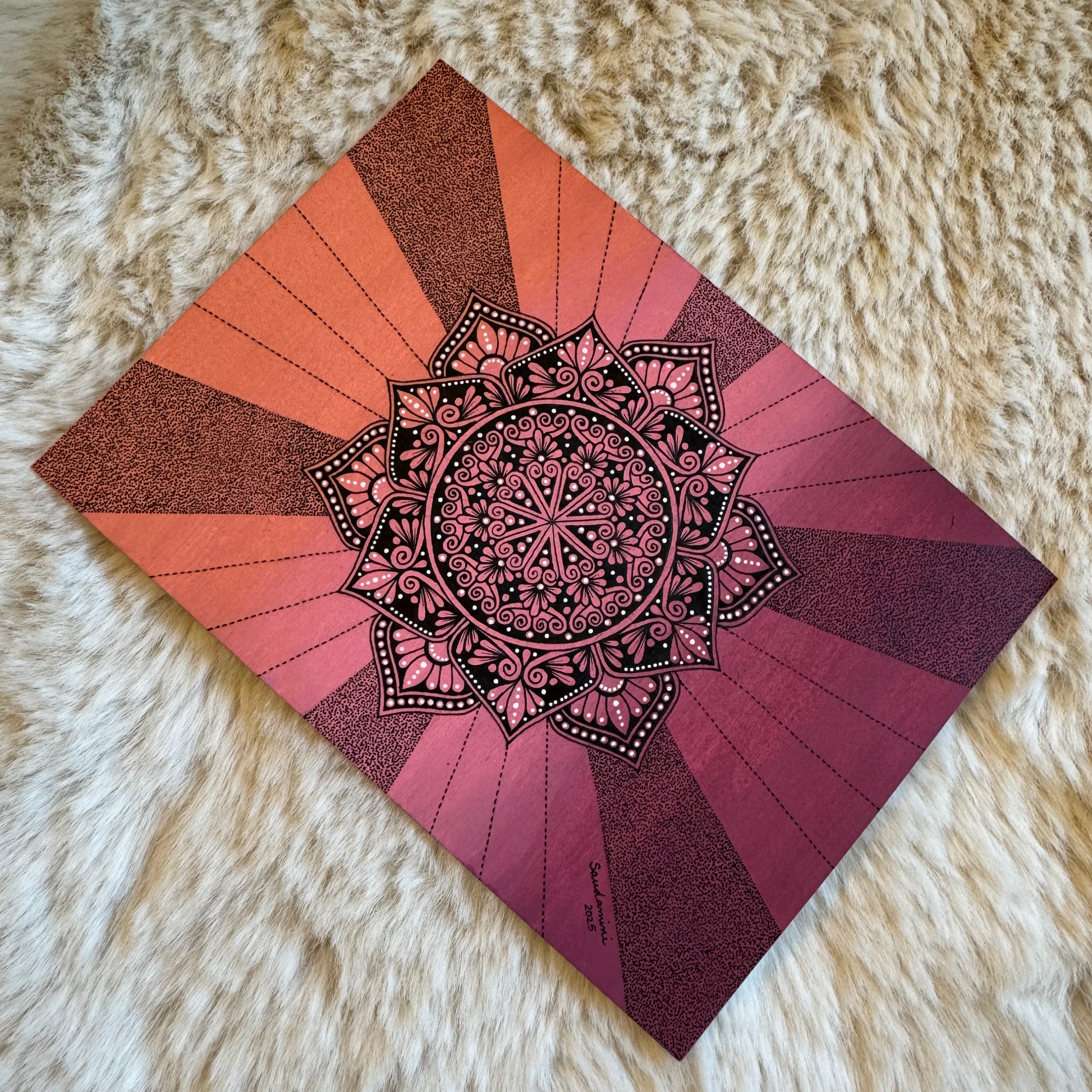 Decorative mandala design on a fluffy white surface