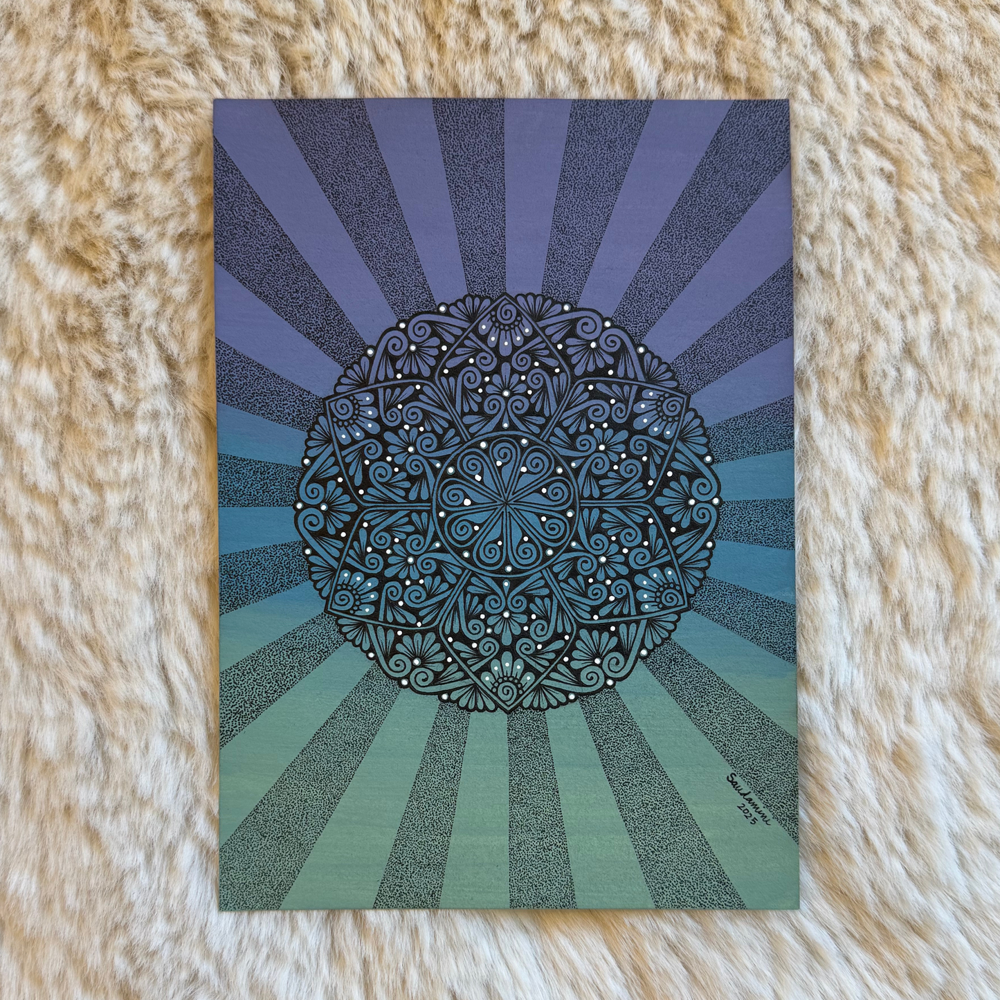 Decorative card with a mandala design on a textured surface