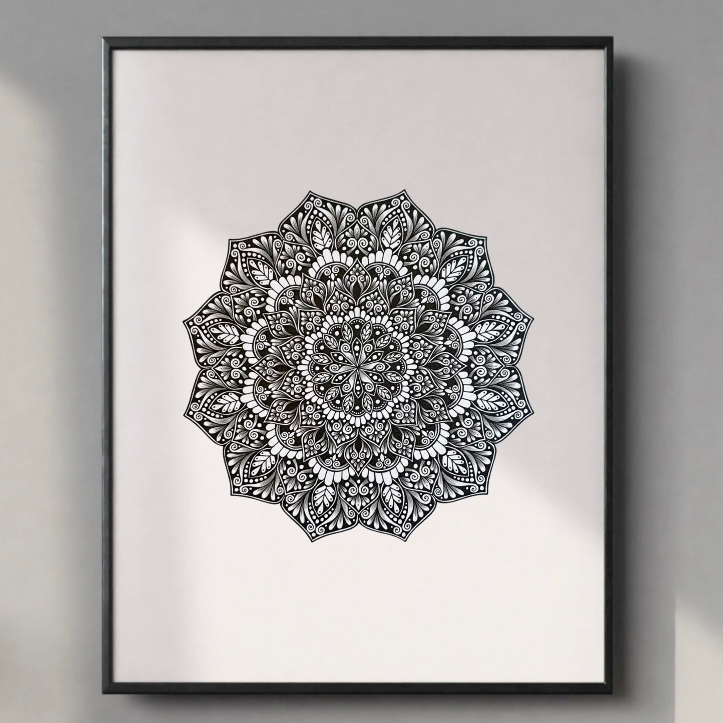 Black and white mandala art print on a light gray background