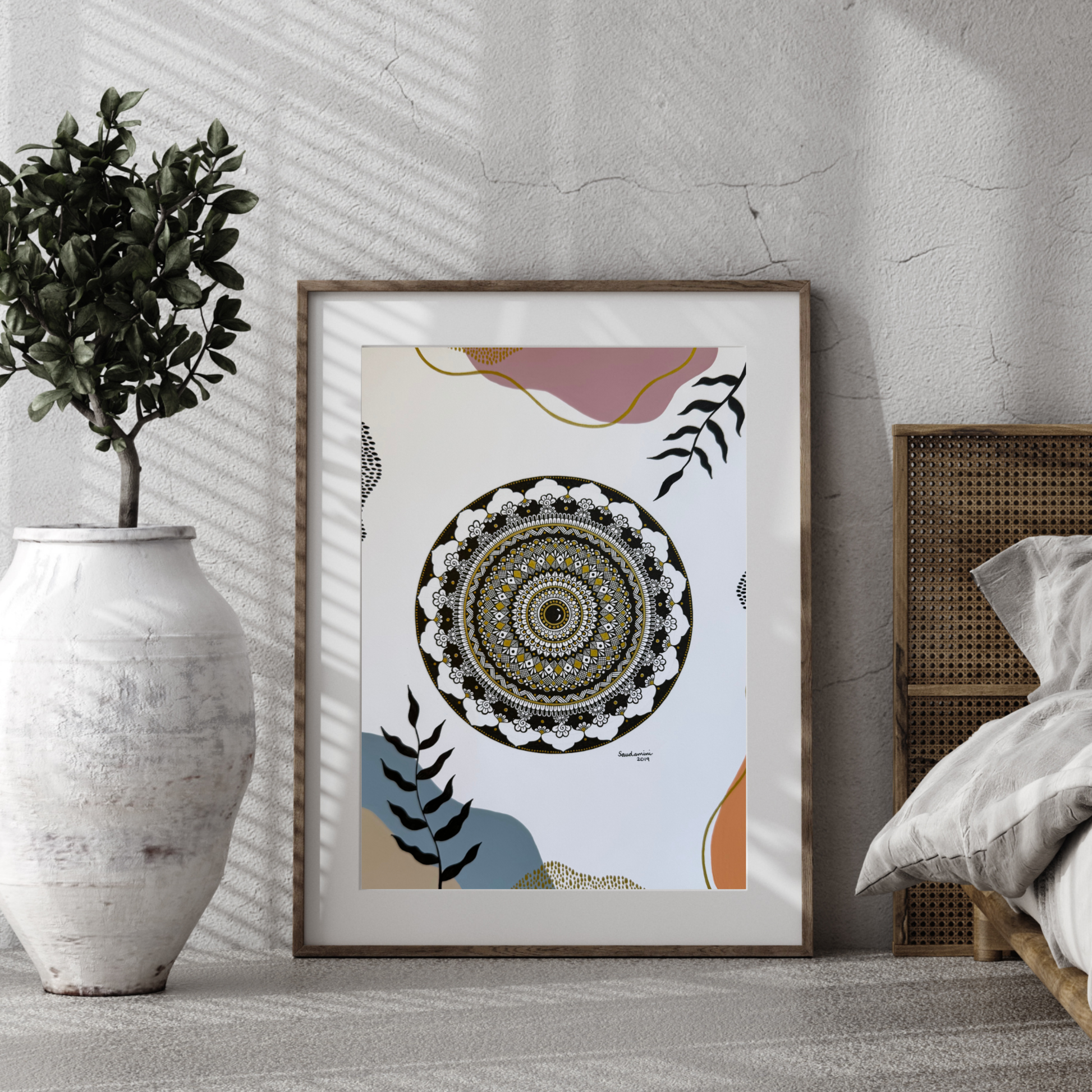 Mandala original artwork on a wall with a plant and bed in the background