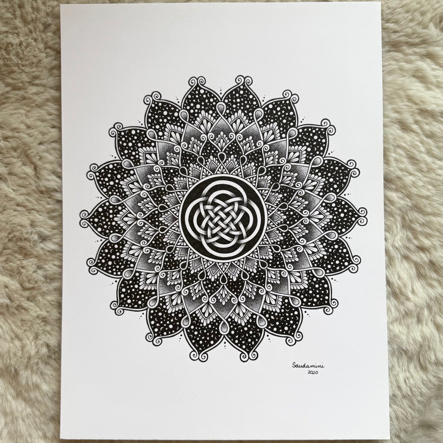 Hand-drawn mandala artwork by Saudamini Madra showing radiating petal forms in black ink on Bristol paper
