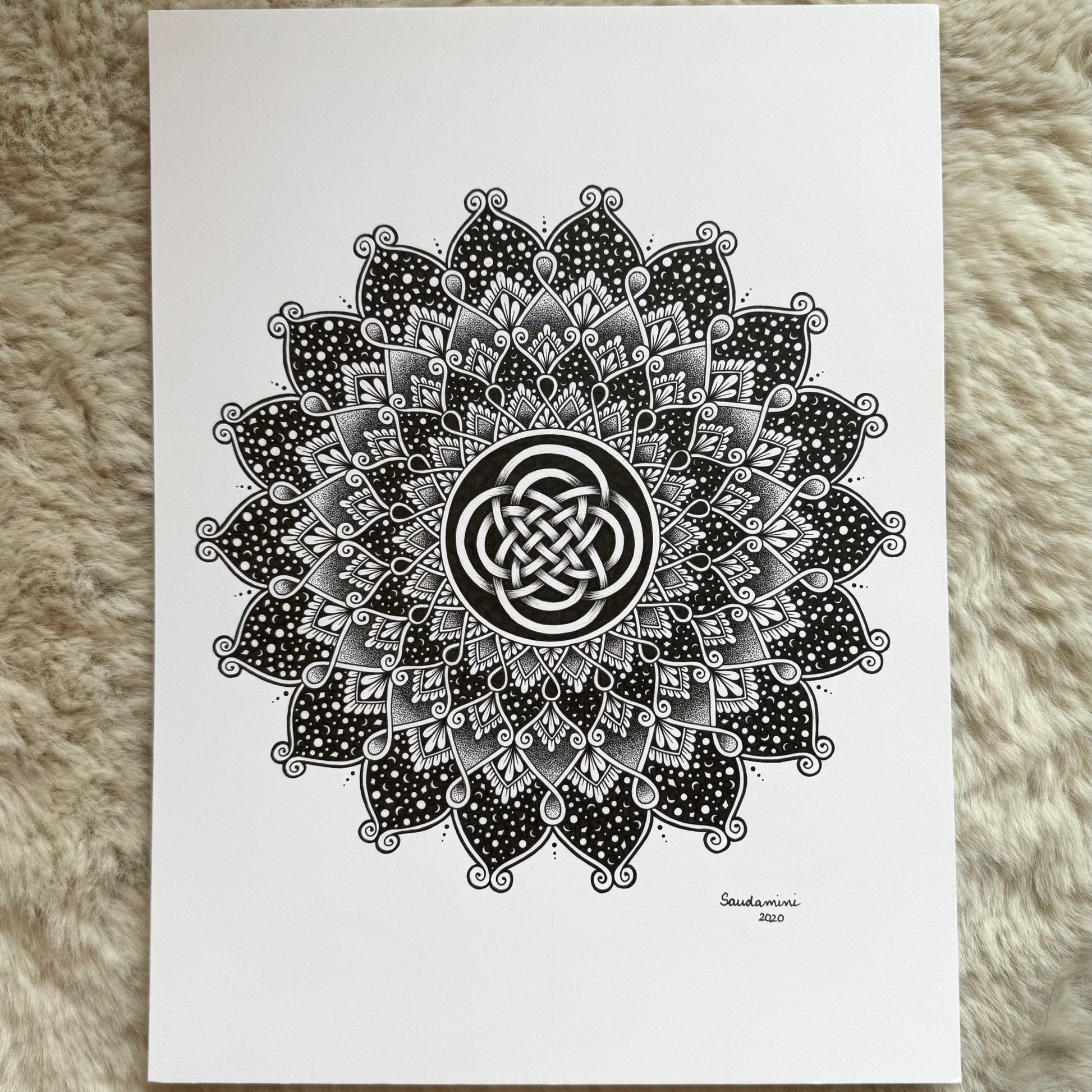 Hand-drawn mandala artwork by Saudamini Madra showing radiating petal forms in black ink on Bristol paper