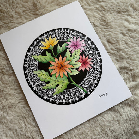 Hand-drawn floral mandala by Saudamini Madra with yellow, orange, and pink flowers in ink and color on Bristol paper, photographed on textured surface