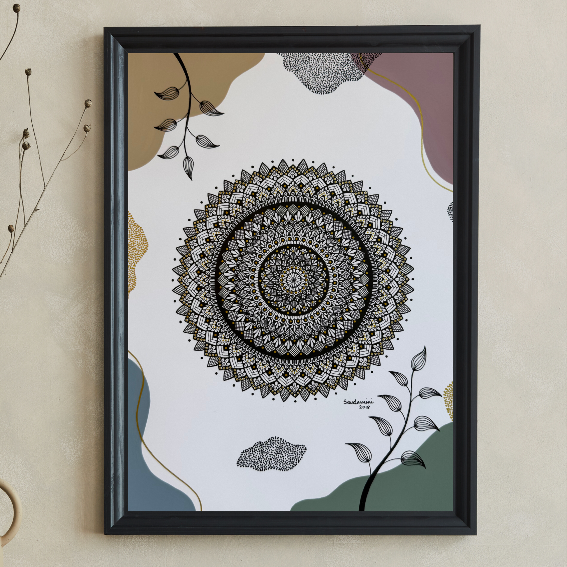 Framed mandala art on a wall with decorative elements