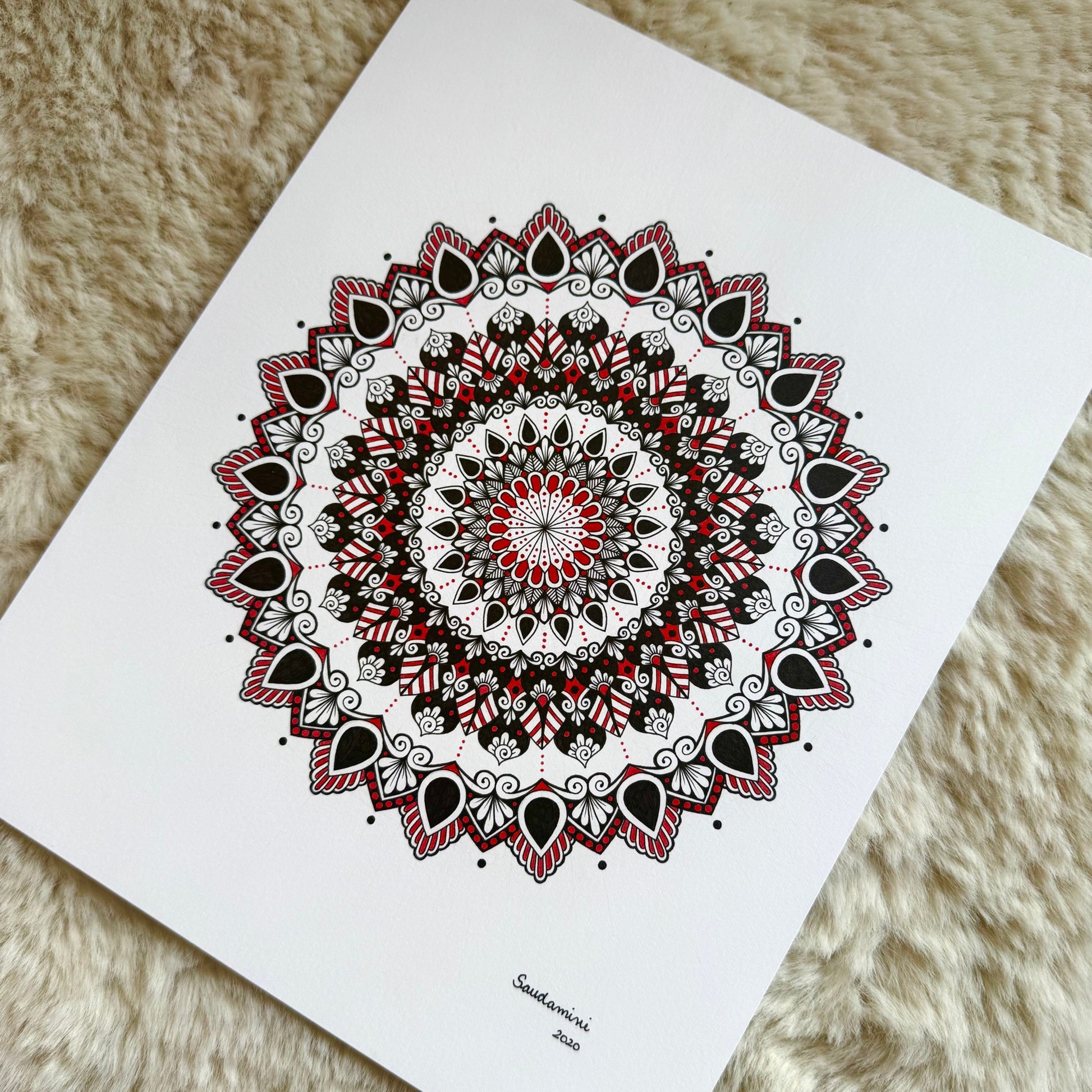 Hand-drawn mandala by Saudamini Madra with red accent details in black ink on Bristol paper, detail view