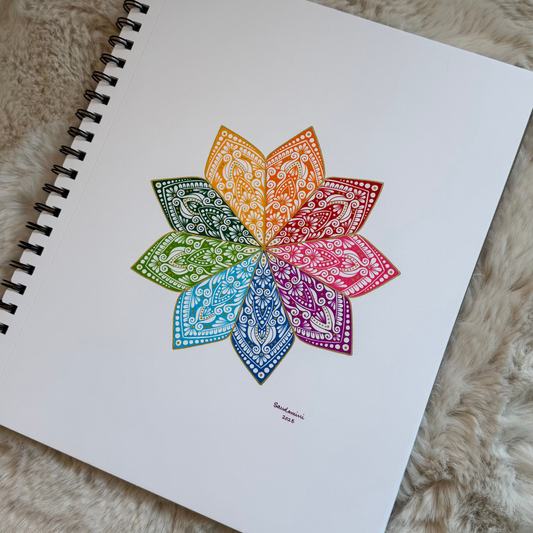 Colorful mandala drawing on a spiral-bound notebook with a textured surface background