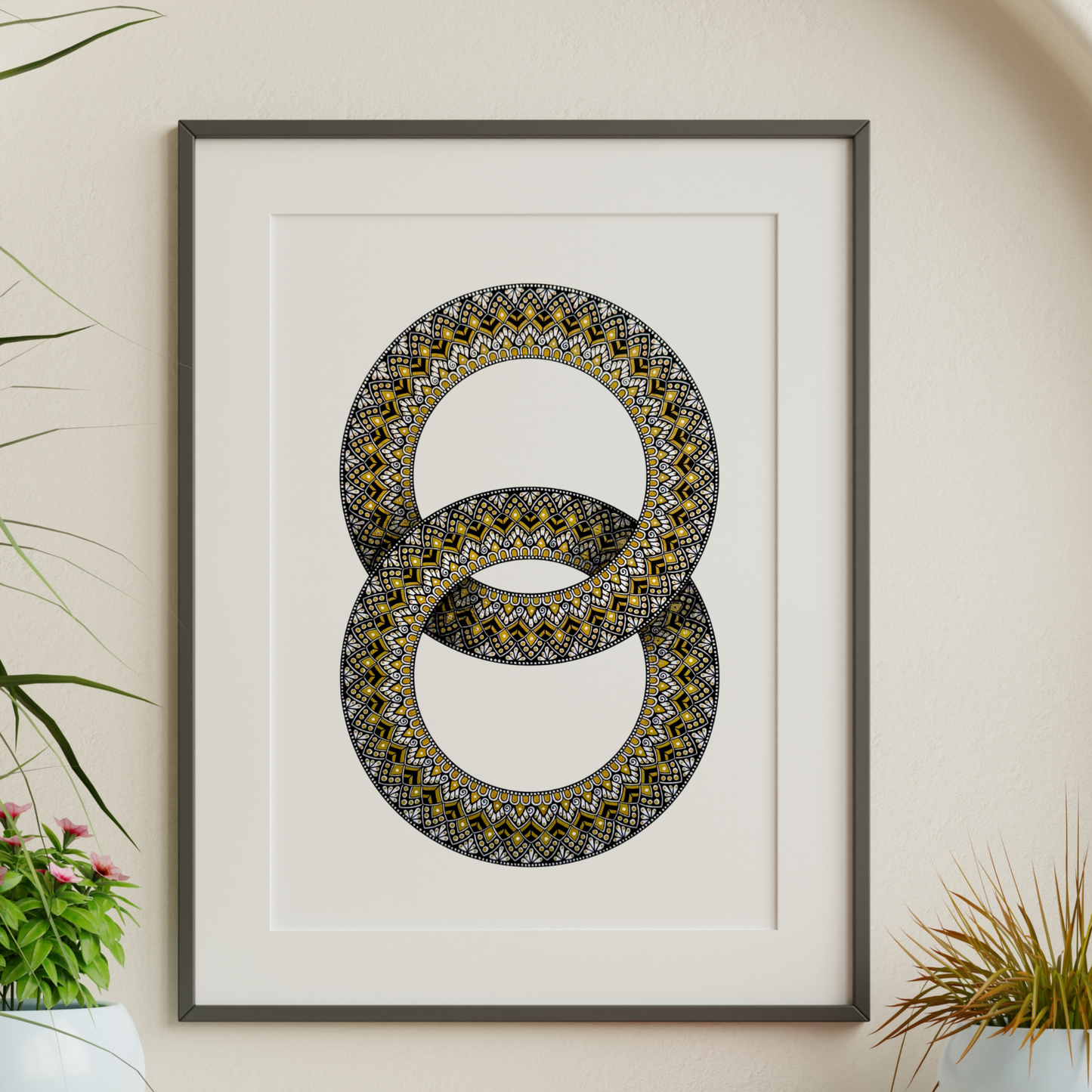 Zentangle design within two interlocking rings artwork hanging on a wall with decorative plants