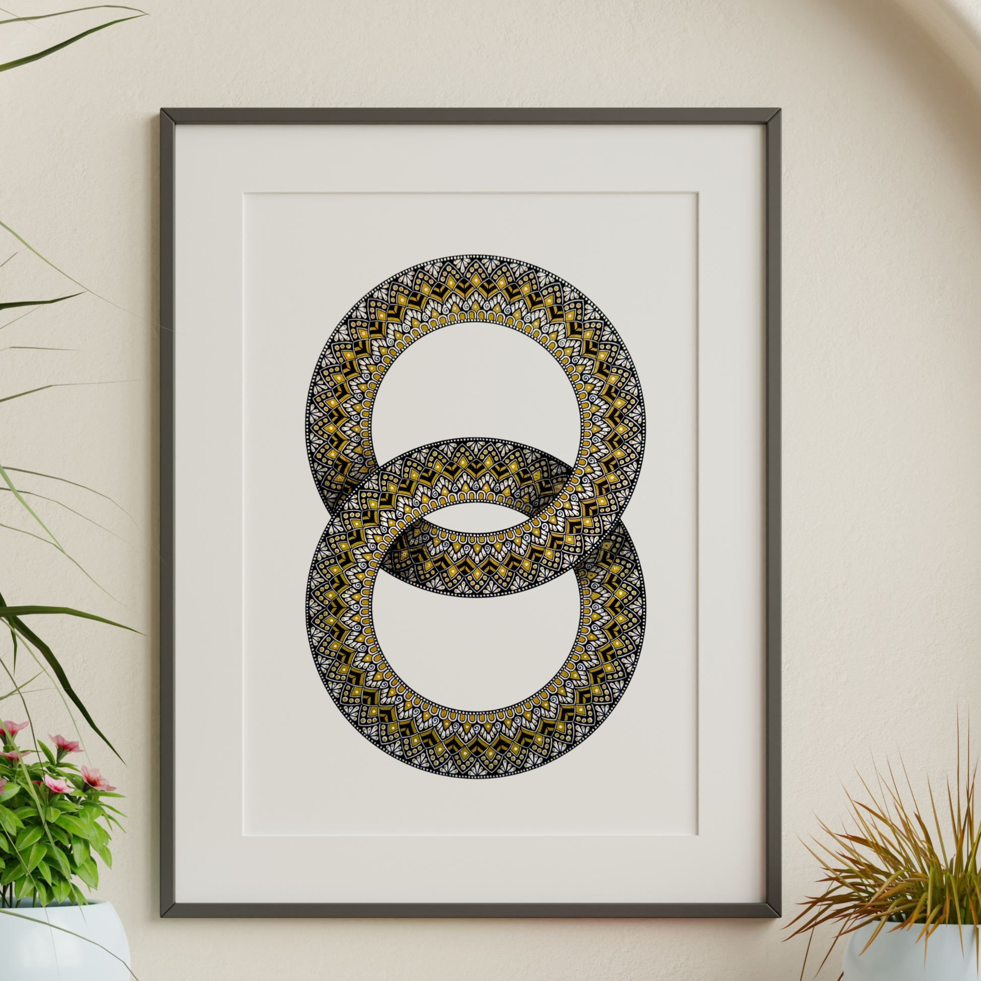 Zentangle design within two interlocking rings artwork hanging on a wall with decorative plants