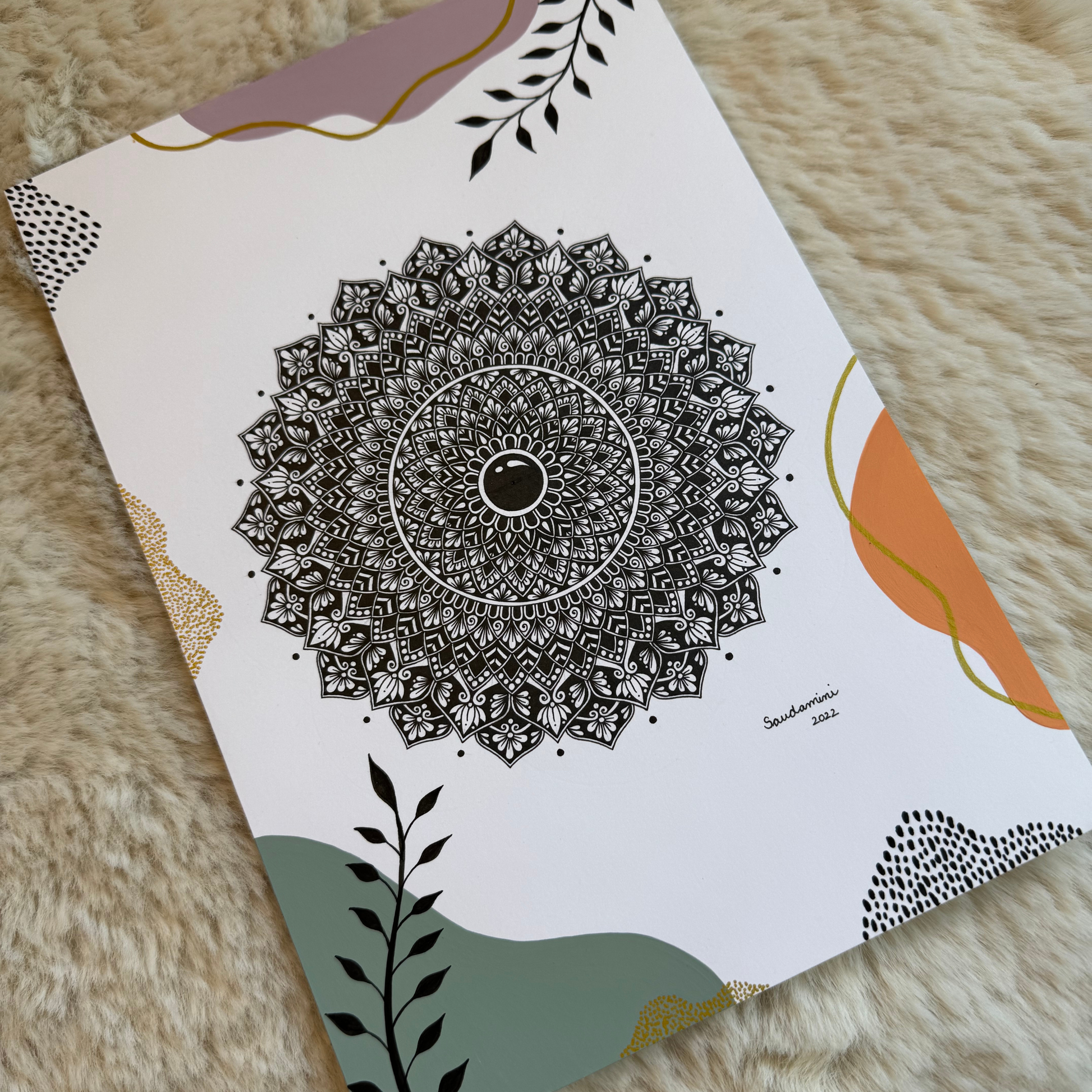 Decorative paper with intricate black mandala design on a textured surface