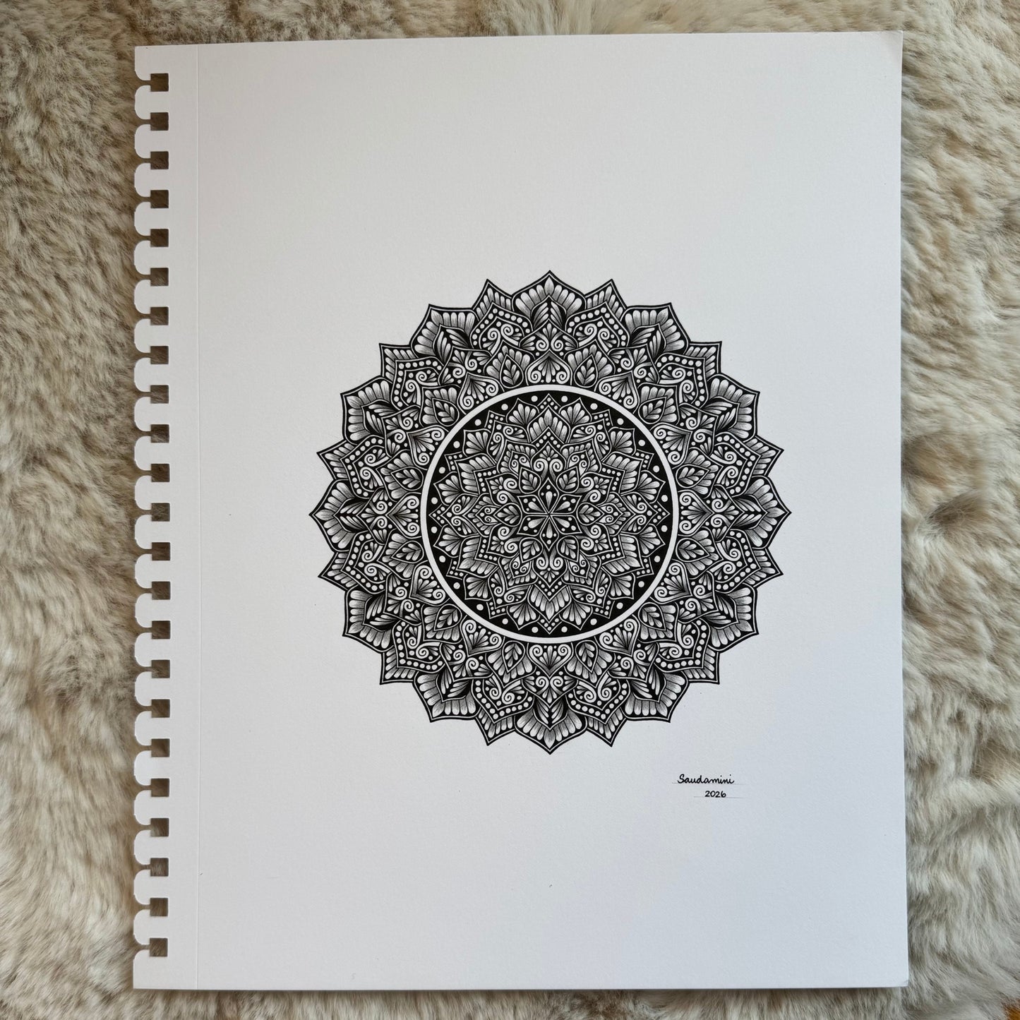 Hand-drawn mandala by Saudamini Madra showing fine black ink patterning on Bristol paper